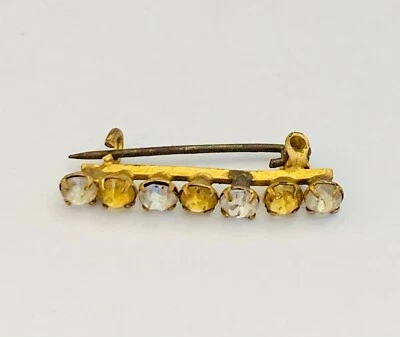 Broche ancienne en métal doré entourée de pierres - Photo 1/4