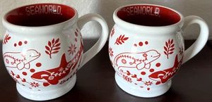 Set of 2 SeaWorld Nordic Holiday 12 oz Mugs Beluga Dolphin Penguin Turtle New! - Picture 1 of 7