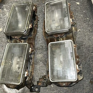 1991 Isuzu NPR HEADLIGHT BEZEL BRACKETS LEFT RIGHT - Picture 1 of 3