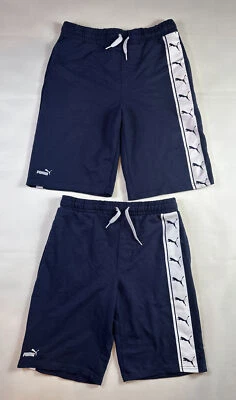 Conjunto de 2 pantalones cortos PUMA ropa deportiva para niños jóvenes talla XL y L azul/blanco cintura elástica usado en excelente estado. Foto 1 de 4