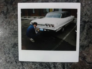 Polaroid Photo of 63 Chevy and Man Bending down at the License Plate Vintage - Picture 1 of 1