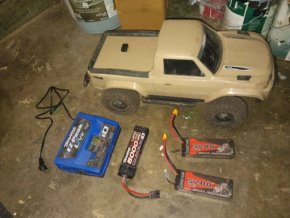 tan traxxas trx 4 used, with 3 batteries, charger, and tamiyama too trax convert - Image 1 of 4