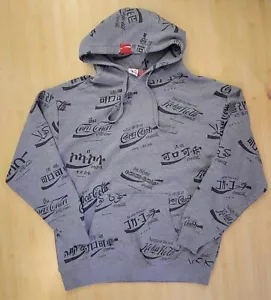 Neu mit Etikett Coca Cola Herren Hoodie Gr. Large grau Allover-Druck Sprachen Welt 424121 - Bild 1 von 15