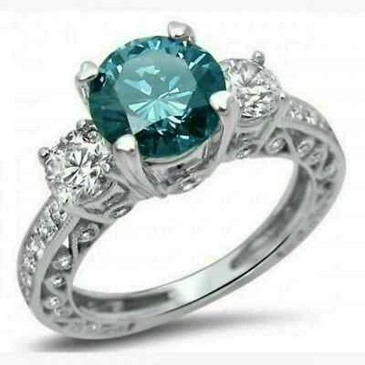 Anillo de compromiso de tres piedras con diamantes azules creado en laboratorio de 3 quilates acabado en oro blanco de 14 k Foto 1 de 4