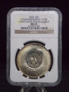 UNITED STATES 1922 1978 CAMP DAVID COUNTERSTAMPED PEACE DOLLAR SLAB NGC MS 65 - Picture 1 of 2