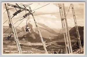 RPPC Alberta, Canada Woman on Banff Chair Lift (Byron Harmon) Unposted Postcard - Picture 1 of 3