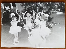 Beautiful girls dancing in Christmas costumes near Christmas tree. Vintage photo
