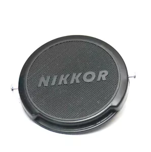 GENUINE OEM BRANDED NIKON NIKKOR 52MM FRONT LENS CAP CHROME BUTTON CLIP ON - Picture 1 of 2