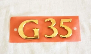 2003 - 2006 INFINITI "G35" 24K GOLD PLATED EMBLEM LETTERS 84895-AM600 - Bild 1 von 2