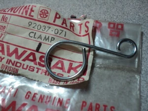 1972-75 KAWASAKI H2 MACH IV FRONT BRAKE CABLE HOLDER CLAMP NOS OEM 92037-071 - Picture 1 of 1