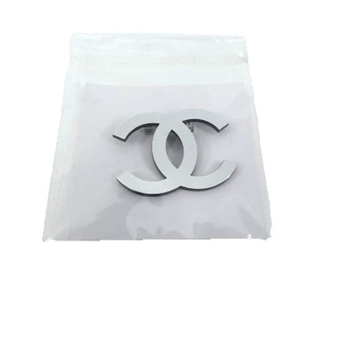 Authentic CHANEL Acrylic CC Logo Silver VIP Gift Pin ,1.75" x 1.5". Plastic Seal - Image 1 of 2