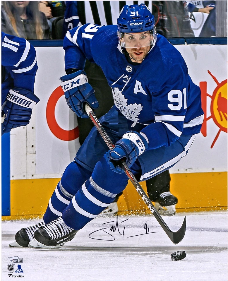 John Tavares Toronto Maple Leafs Signed 16 x 20 Blue Jersey Skating & Puck Photo - Image 1 of 1