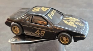 VINTAGE TYCO PONTIAC FIERO 48 CHALLENGE HO SLOT CAR W CHASSIS RUNS BLACK GOLD - Picture 1 of 7