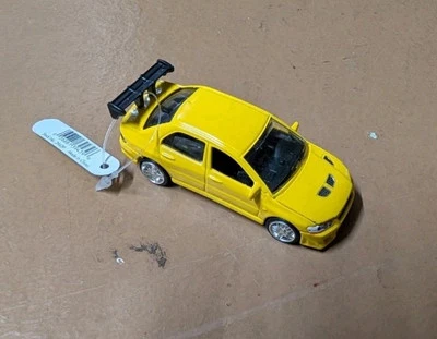 Coche de colección Racing Champion amarillo Mitsubishi Lancer Evo VII 1:64 Ertl 2002 Foto 1 de 4