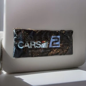 Project Cars 2 Sunglass Pouch Promo MOLTO RARO 🔥 Nuovo Sigillato PS4 XB1 Bandai Namco - Foto 1 di 13