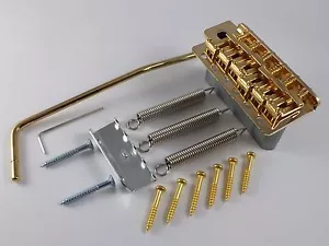 PONTE TREMOLO ORO VINTAGE, BRACCIO TREM con SELLE IN ACCIAIO PIEGATE per Stratocaster - Foto 1 di 7