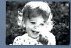 FOUND B&W PHOTO D_8990 PORTRAIT OF GIRL SMILING POINTING FINGER AT CAMERA