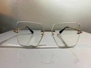 Gafas unisex, sin montura, oversize con lentes transparentes y montura de alambre dorado. - Imagen 1 de 12