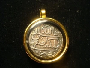 MUSLIM silver coin 18th Century in glass  and Gold plated bezel. - Picture 1 of 4