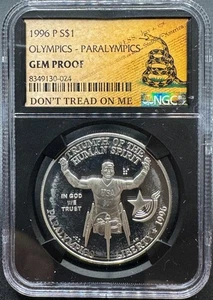 1996-P PARALYMPICS COMMEMORATIVE SILVER DOLLAR NGC DON'T TREAD ON ME LABEL GB - Picture 1 of 4