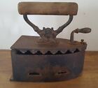 ANTIQUE CAST IRON CLOTHES IRON WITH WOODEN HANDLE AND DEVIL DECOR