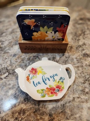 JUEGO DE MONTAÑA RUSA MUJER PIONERA CON SOPORTE DE MADERA Y SOPORTE PARA BOLSA DE TÉ Flores Foto 1 de 4