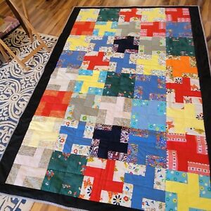 Handmade quilt which measures 88 by 60 inches and is made of cotton fabric