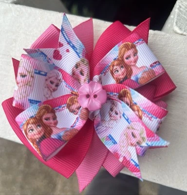 Moño de pelo rosa Disney Frozen Elsa Anna molinete en capas con centro de botones Foto 1 de 2
