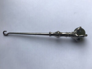 RARE VICTORIAN WHITE METAL SHOE BUTTON HOOK WITH ROUND CARNELIAN IN CLAW