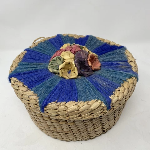 hand woven round basket weave with yarn floral design from Mexico. Decorated lid Cover