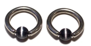 2- 10g 1/2 Black Cat Eyes Captive Ring Nipple Lip Nose 316L SS Body Jewelry Sexy - Picture 1 of 2