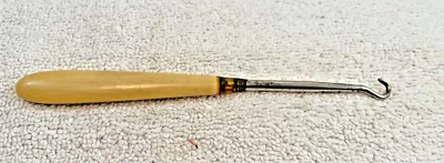 Antiguo gancho corsé botón zapato hueso baquelita metal Foto 1 de 4