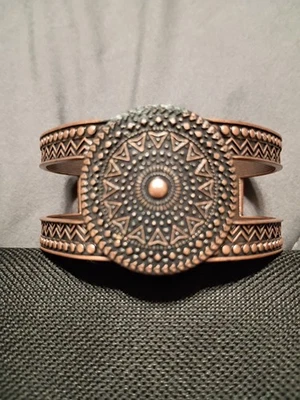 This is a handcrafted copper cuff bracelet with an embossed design. - Image 1 of 2