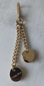 Calvin Klein GOLD METAL LOGO Double Key Or Bag CHARM Hang Tag ACCENT Imprinted - Picture 1 of 9