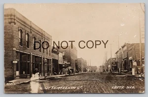 Crete NE RPPC West 13th Street Stores Trunk Gloves Signs Dirt Rd Postcard N1 - Picture 1 of 2