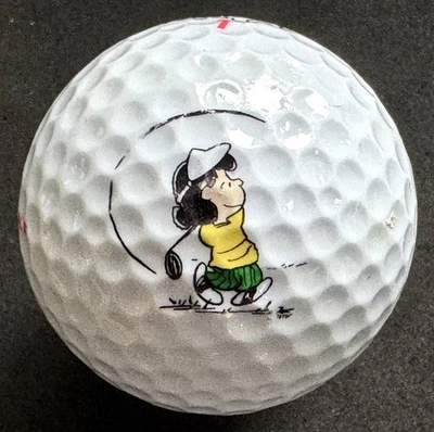 Pelota de golf Charlie Brown Peanuts - Lucy Golfing LOGO Foto 1 de 4