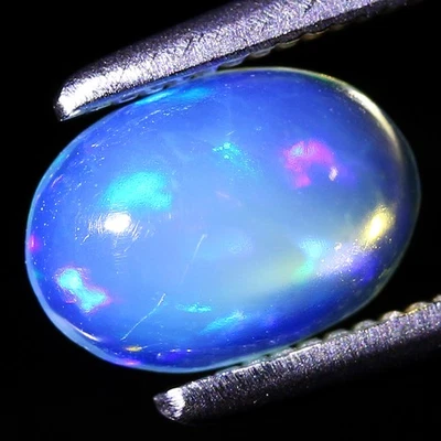 Piedra preciosa de ópalo arco iris natural cabina ovalada de 0,45 quilates ancho 6,9 x 4,9 mm, Etiopía Foto 1 de 4