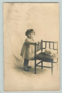 POSTCARD Baby girl, standing. Studio portrait. RPPC - Picture 1 of 2