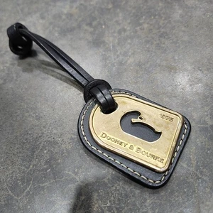 Bolso rectangular Dooney and Bourke de latón y cuero negro con dije logotipo de pato 1975 - Imagen 1 de 5