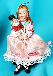 KURT ADLER BY JOCELYN MOSTROM 'LITTLE GIRL HOLDING TOY SOLDIER' ORNAMENT - Picture 1 of 9