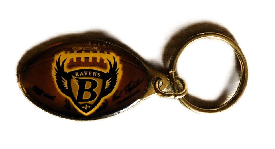 VINTAGE BALTIMORE RAVEN LOGO NFL FOOTBALL SHAPED CLOISONNE OVER MEDAT KEYCHAIN - Image 1 of 2