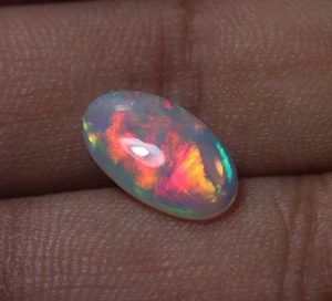 Cabujón ovalado ópalo etíope 2 quilates 13,9x8 mm natural AAA rojo verde amarillo fuego - Imagen 1 de 8