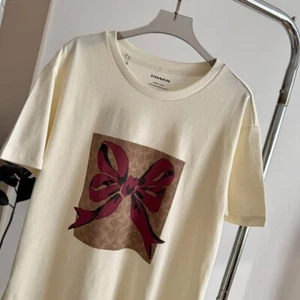 NUEVO CON ETIQUETAS COACH Camiseta para mujer Bowknot algodón orgánico - Imagen 1 de 6