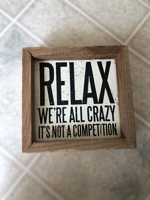 Letrero divertido "Relax We're All Crazy It's Not A Competition" - Caja de sombra rústica 5" Foto 1 de 3