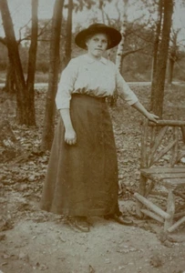 Woman Wearing Hat Standing With Hand On Wood Chair Photo RPPC - Picture 1 of 3