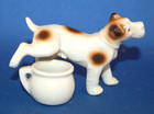 A super antique terrier dog figure, porcelain, with chamber pot