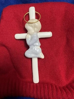 Bebé rezando en una cruz Foto 1 de 3