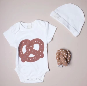 NEU im Paket: Estella NYC Brezel Baby Rassel Bio Baumwolle Plüsch braun Strick - Bild 1 von 4