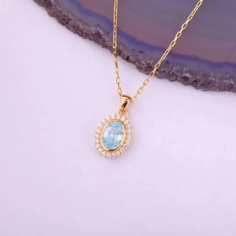 Colgante con halo de aguamarina de corte ovalado de 1,25 quilates enchapado en oro amarillo de 14 quilates de 18" Foto 1 de 4