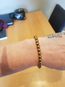 81.55cts Gold haematite 6mm round gemstone stretchy bracelet with silver bead - Picture 1 of 6